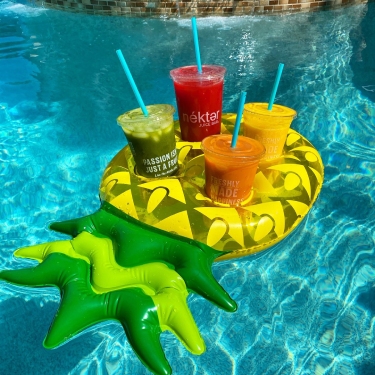 nekter juices on a floatie in a pool